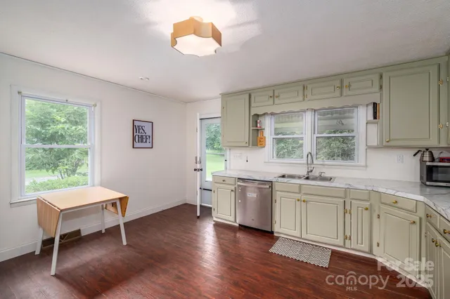 a kitchen with a sink cabinets and window
