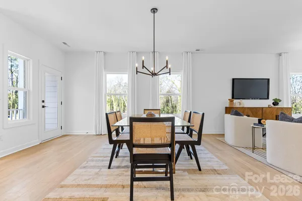 a view of a dining room with furniture window and wooden floor