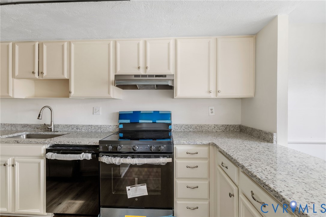 1501 Largo Road, Unit 301 Henrico, VA 23238 - Photo 13 of 40 a kitchen with stainless steel appliances granite countertop a sink stove and cabinets
