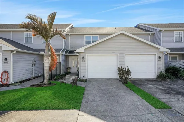 a view of a house with a yard and pathway