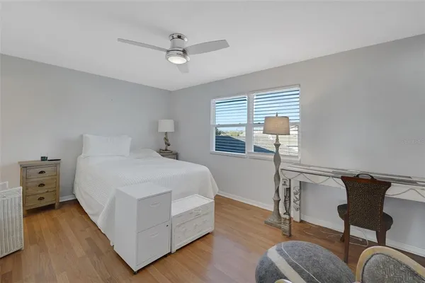 a bedroom with furniture and a window