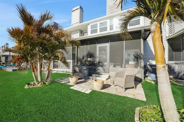 a view of a chair and table in backyard of the house