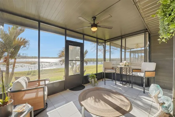 a living room with furniture and a floor to ceiling window
