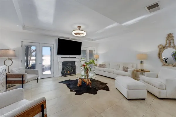 a living room with furniture a fireplace and a flat screen tv