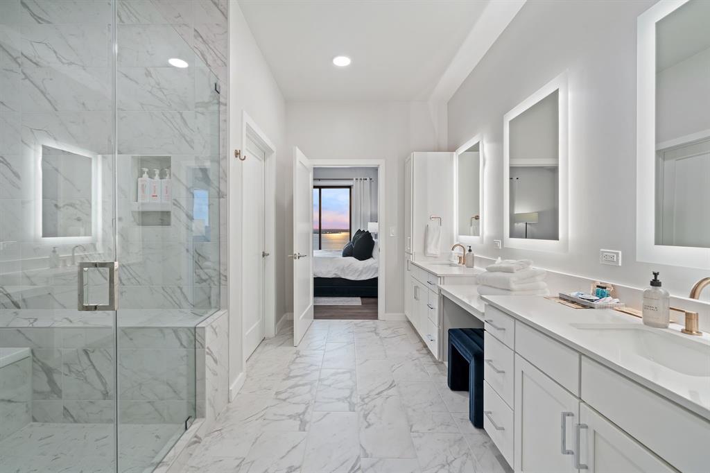 3111 Sunset Boulevard, Unit 915 Flower Mound, TX 75022 - Photo 12 of 39 a bathroom with a double vanity sink a mirror and a shower