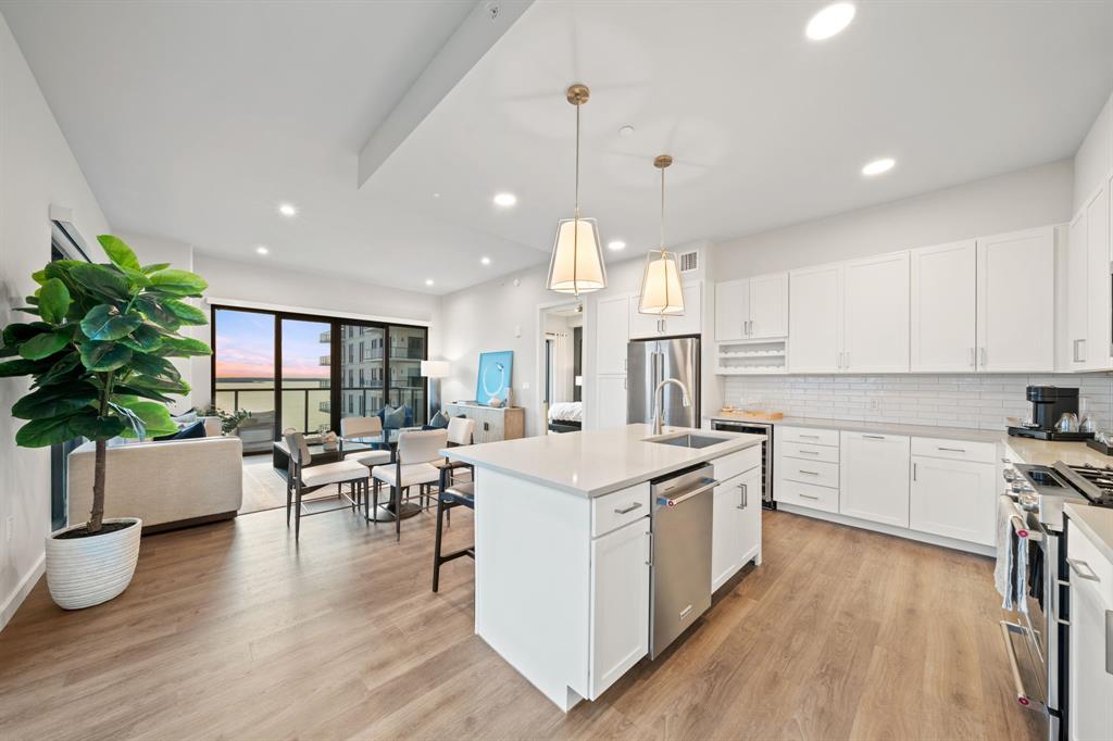 3111 Sunset Boulevard, Unit 915 Flower Mound, TX 75022 - Photo 7 of 39 a kitchen with a table chairs stove and cabinets