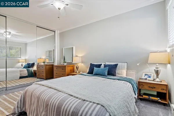 a bedroom with bed and a chandelier