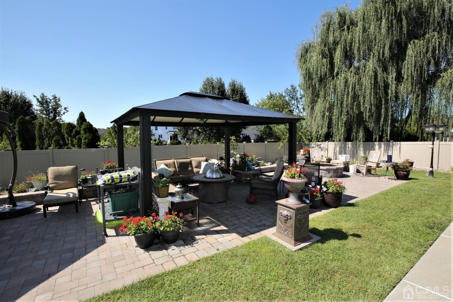 1 MacFarlane Circle Monroe Township, NJ 08831 - Photo 13 of 26 a view of a backyard with sitting area and furniture