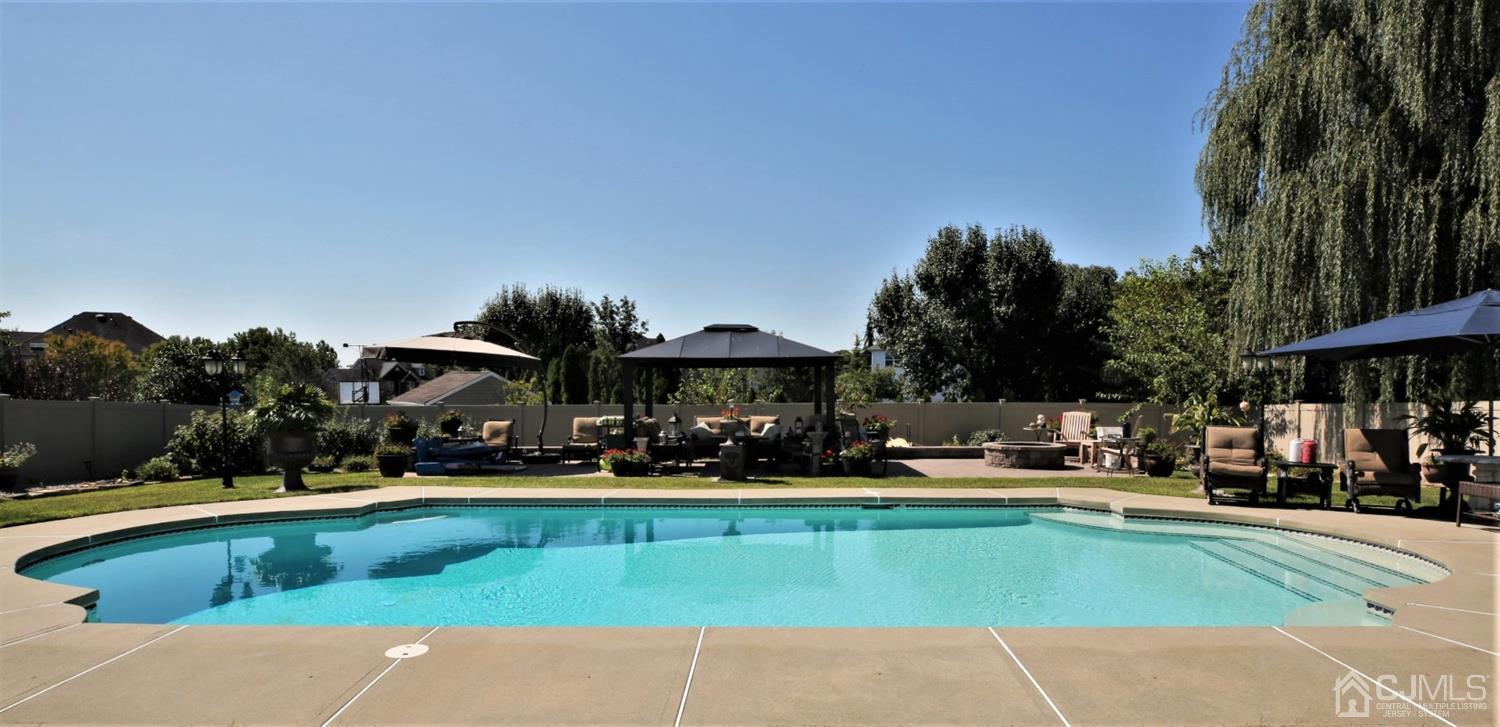 1 MacFarlane Circle Monroe Township, NJ 08831 - Photo 16 of 26 a view of a swimming pool with a lounge chairs