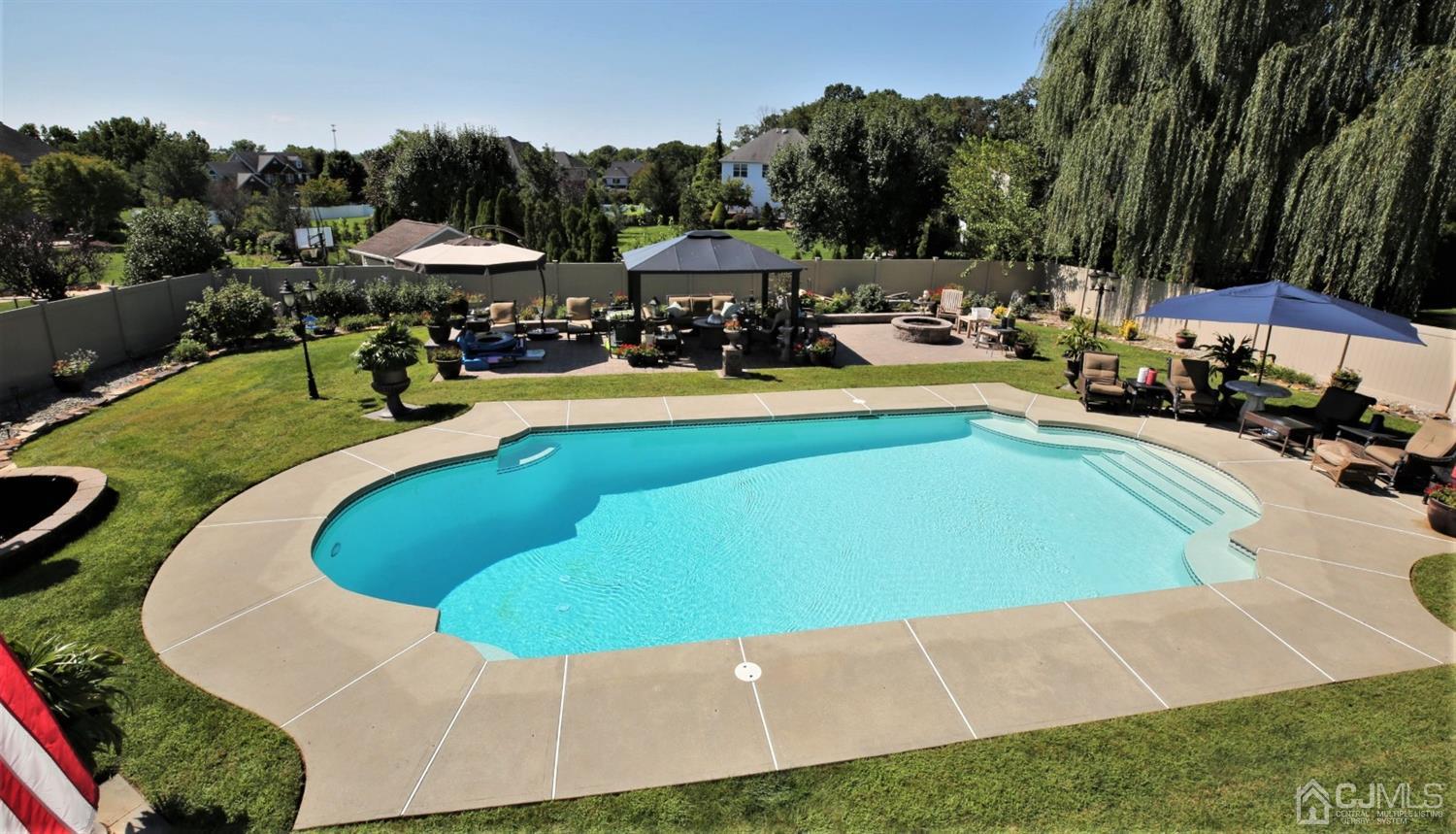 1 MacFarlane Circle Monroe Township, NJ 08831 - Photo 24 of 26 a view of a swimming pool and lounge chairs