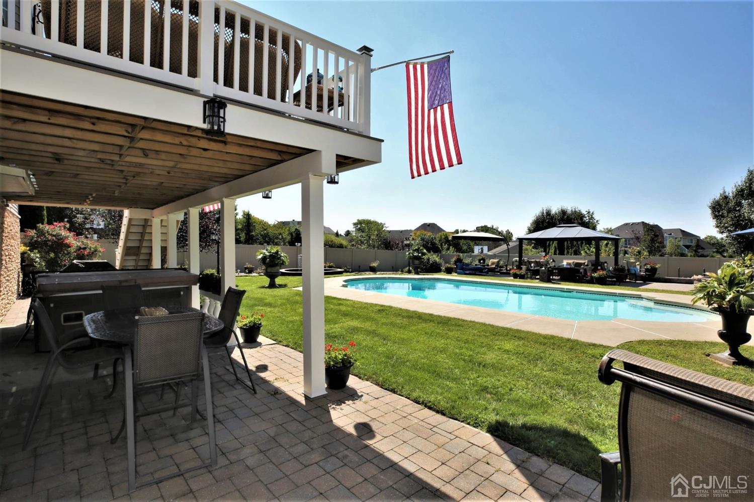 1 MacFarlane Circle Monroe Township, NJ 08831 - Photo 26 of 26 a roof deck with table and chairs a barbeque