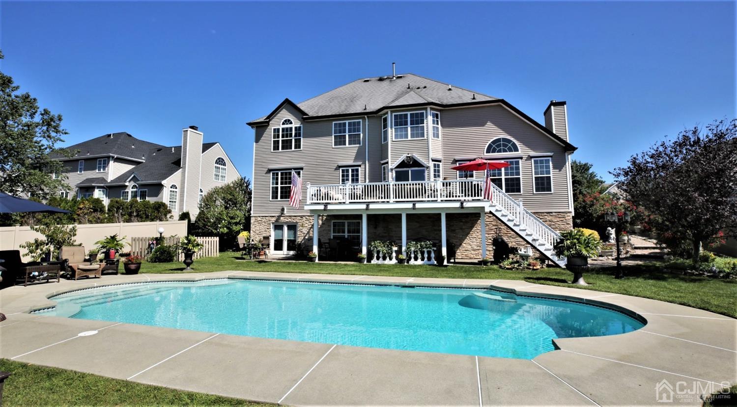 1 MacFarlane Circle Monroe Township, NJ 08831 - Photo 5 of 26 a view of a white house with a swimming pool and sitting area