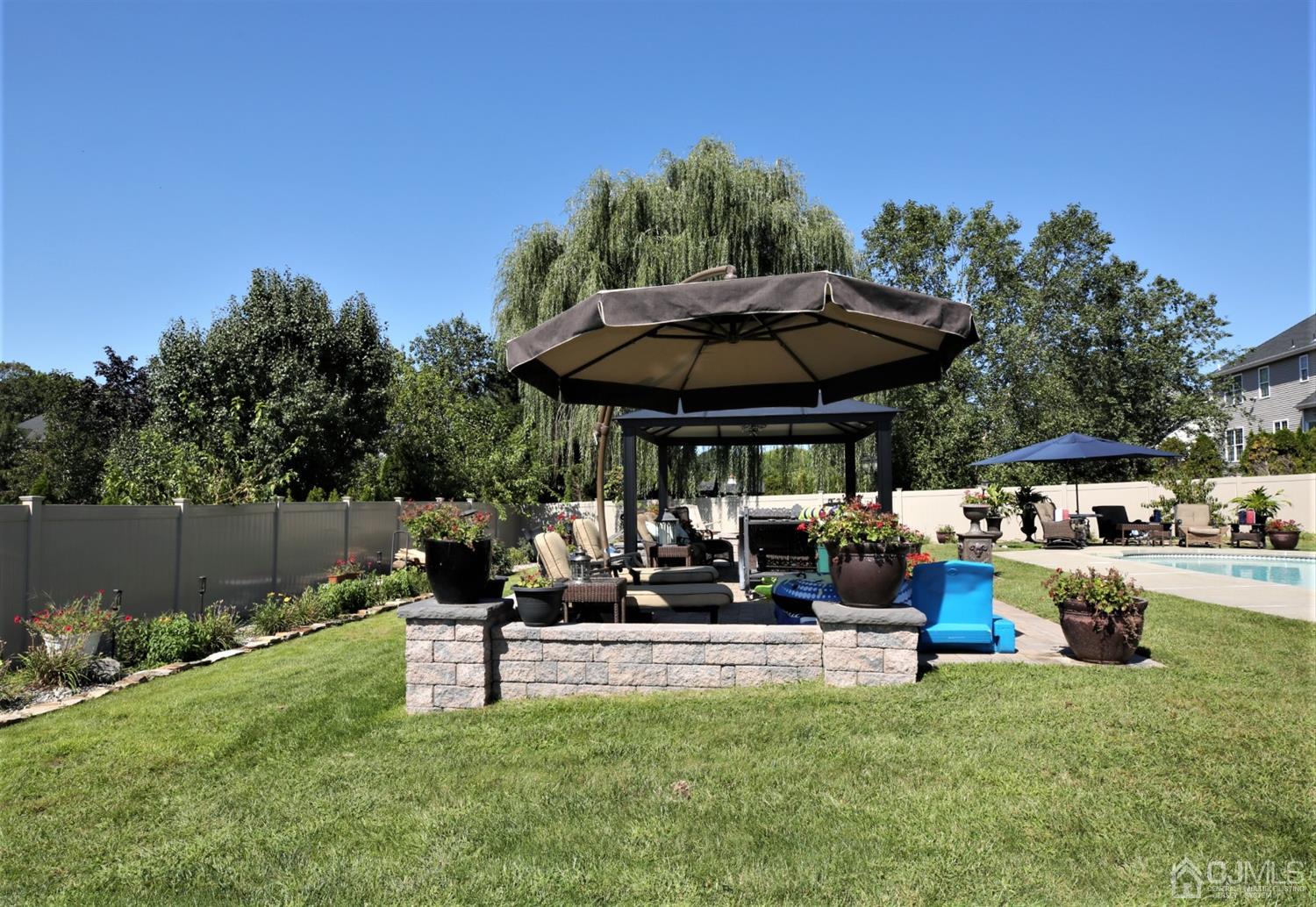 1 MacFarlane Circle Monroe Township, NJ 08831 - Photo 10 of 26 a view of a backyard with sitting area and furniture