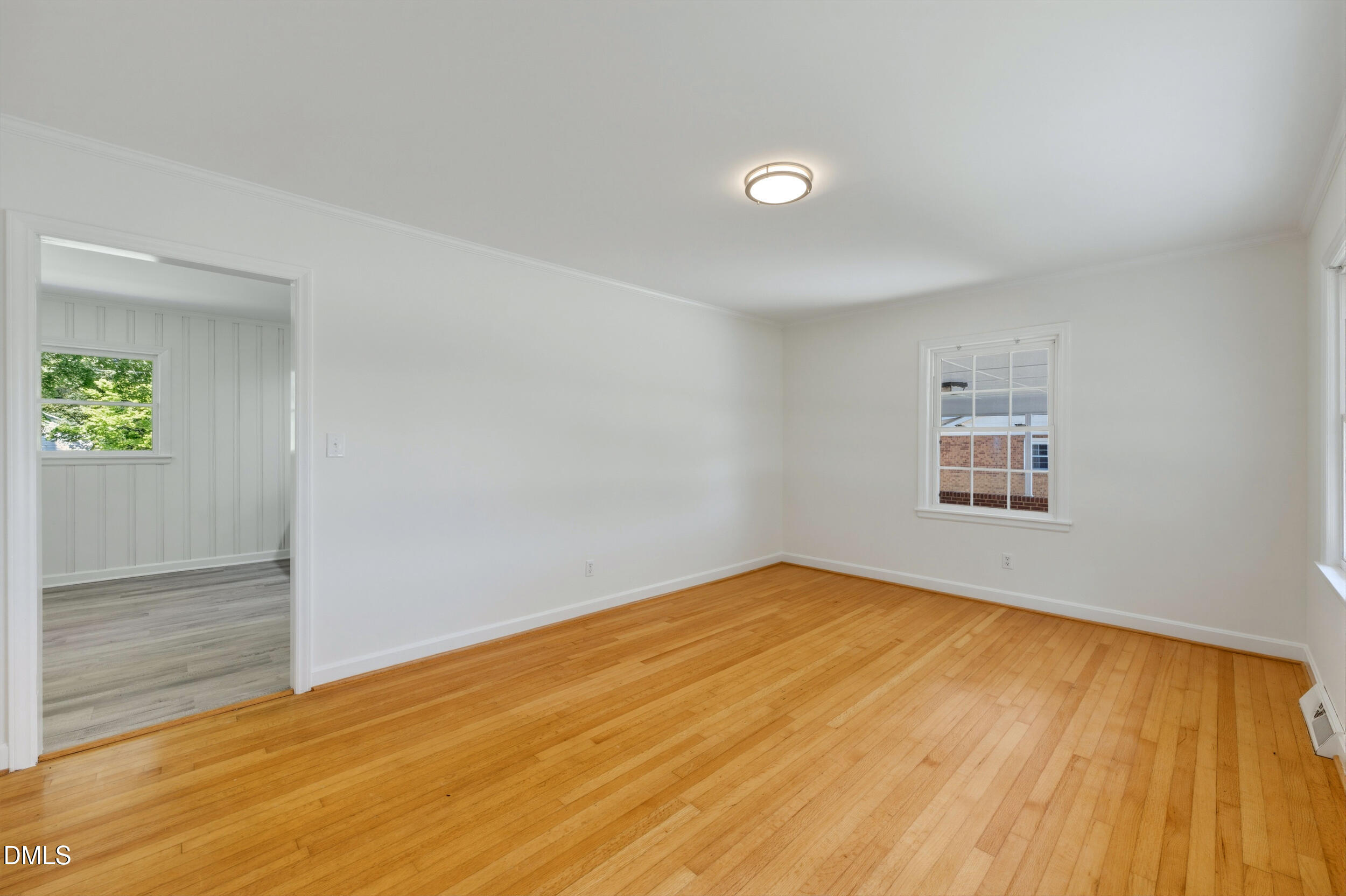 209 North Wilkins Road Haw River, NC 27258 - Photo 6 of 28 a view of an empty room with wooden floor and a window