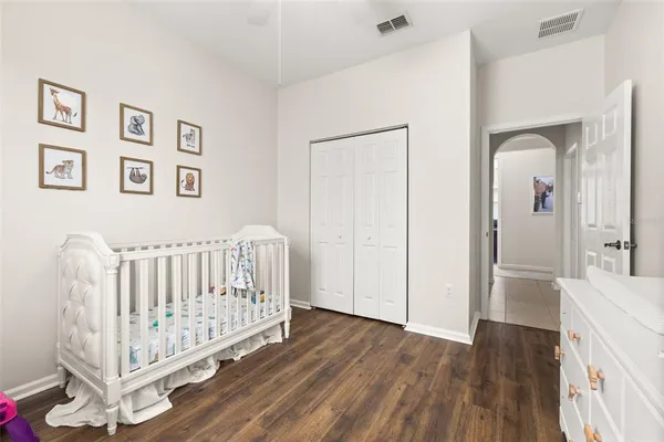 a view of a bedroom with wooden floor