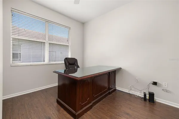 a view of workspace with wooden floor windows