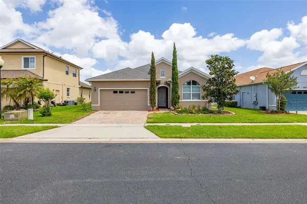 a front view of a house with a yard and garage