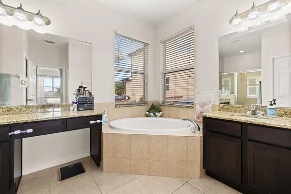 a bathroom with a sink double vanity and a mirror