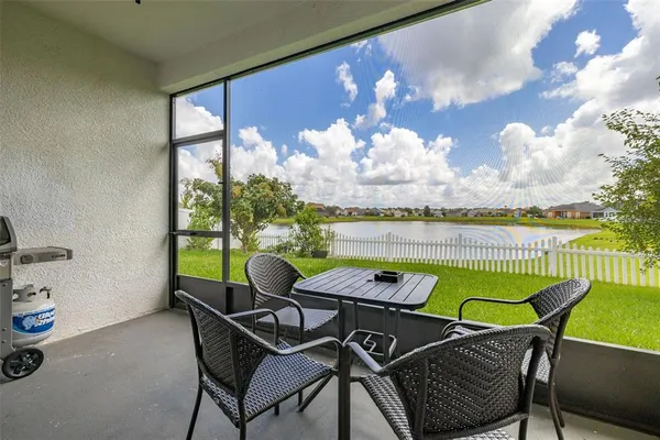 a view of a chairs and table in patio