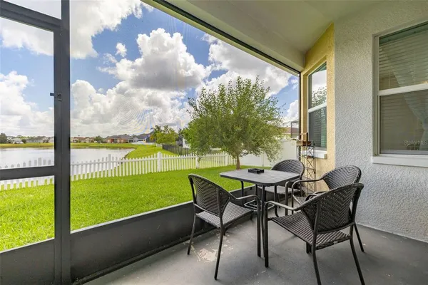 a view of a porch with furniture and a yard