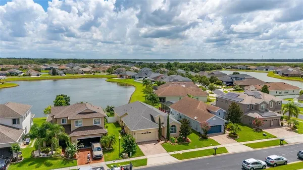 an aerial view of residential building and lake