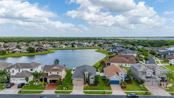 a living room with furniture a flat screen tv and a large window