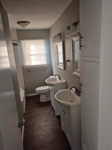 a bathroom with a toilet sink and mirror