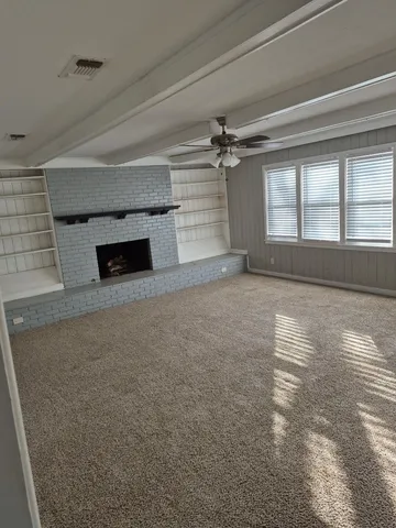 wooden floor in an empty room with a fireplace