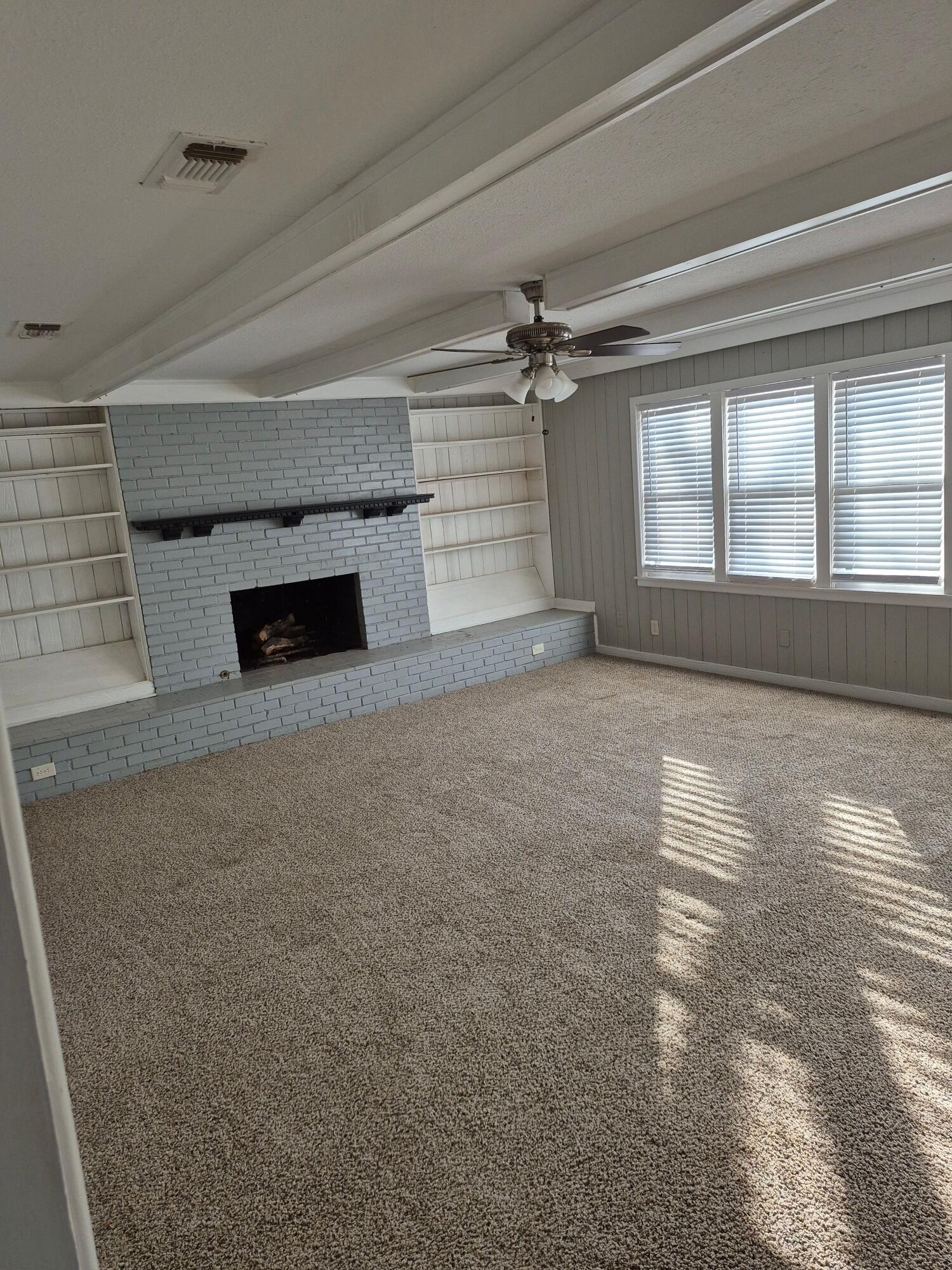 3517 30th Street Lubbock, TX 79410 - Photo 6 of 18 wooden floor in an empty room with a fireplace