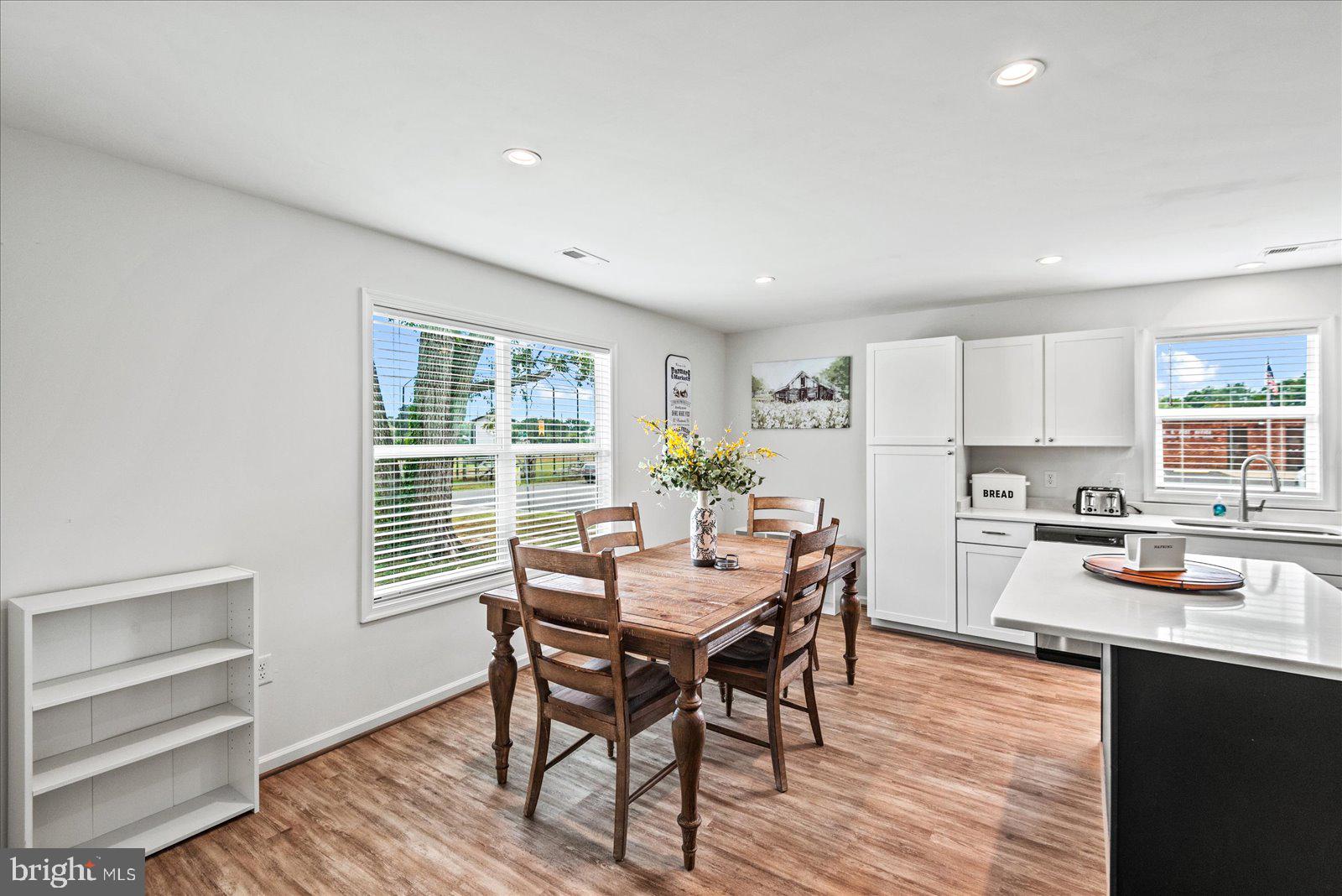 121 1st Street Colonial Beach, VA 22443 - Photo 13 of 46 a view of a dining room with furniture and wooden floor