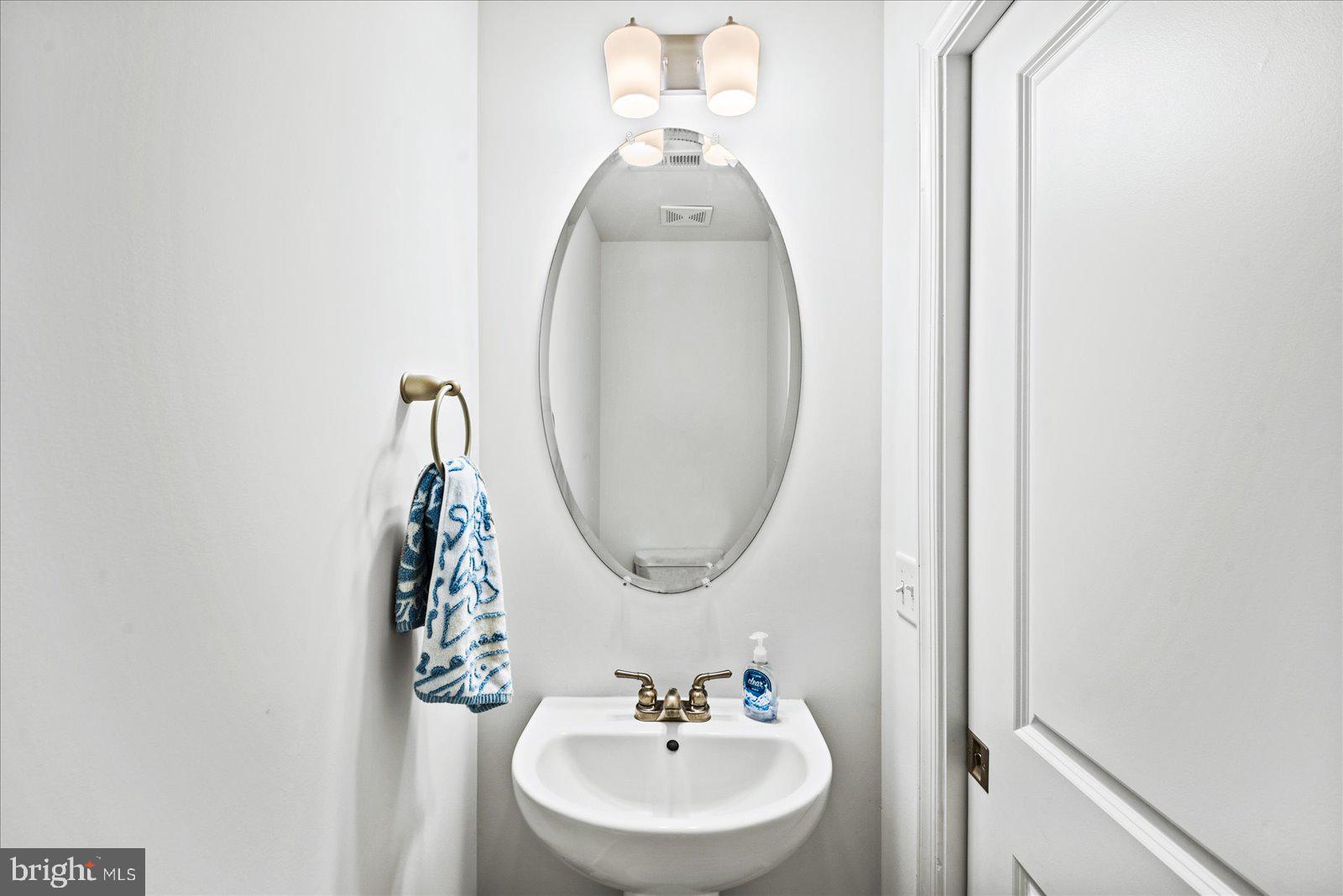121 1st Street Colonial Beach, VA 22443 - Photo 14 of 46 a bathroom with a sink and a mirror