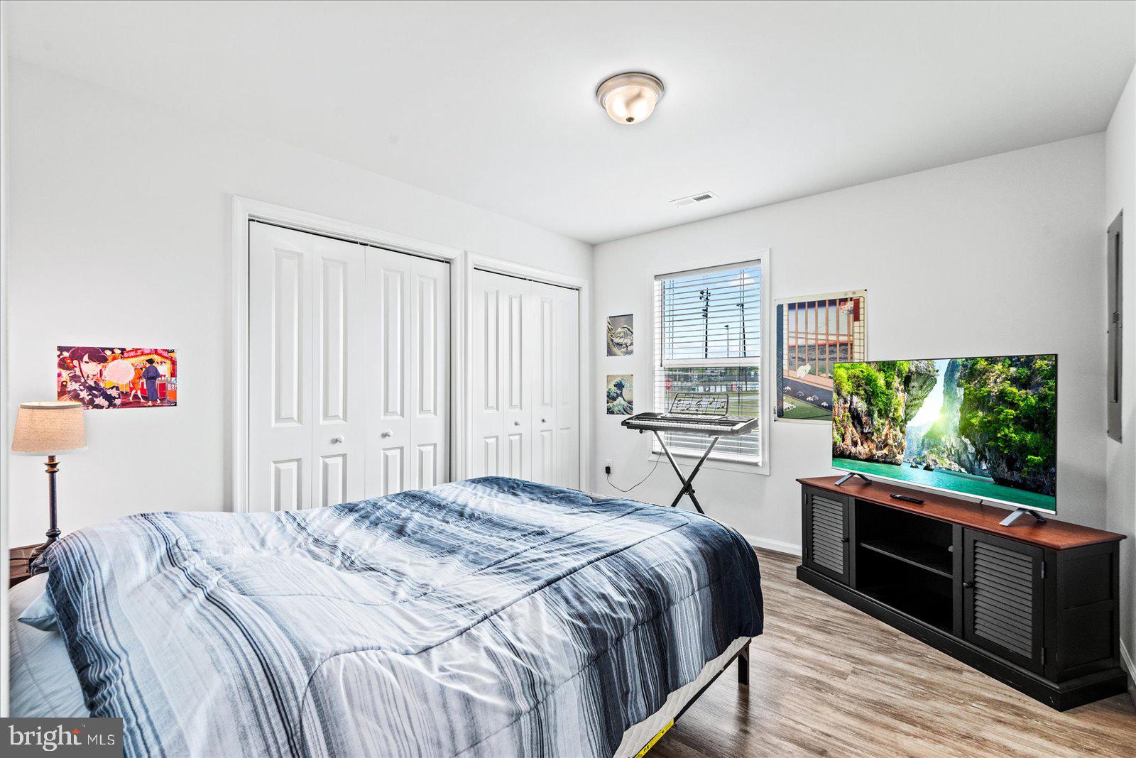 121 1st Street Colonial Beach, VA 22443 - Photo 15 of 46 a bedroom with a large bed and a large window