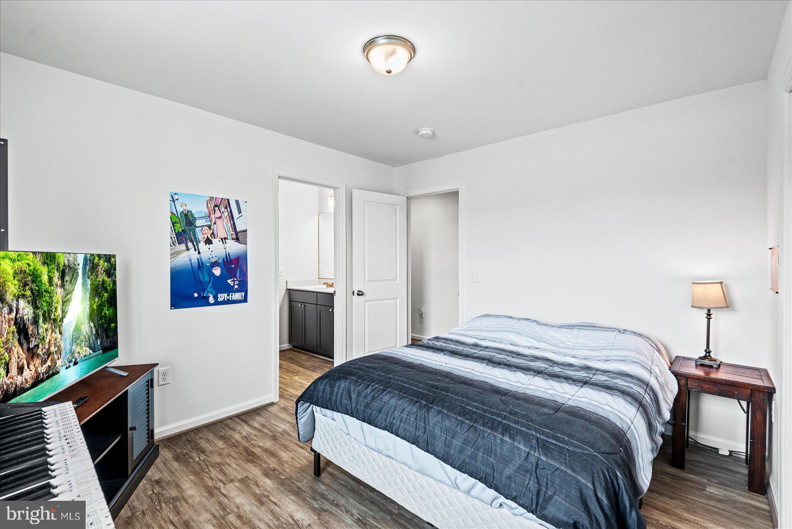 121 1st Street Colonial Beach, VA 22443 - Photo 16 of 46 a bedroom with a bed and a flat screen tv