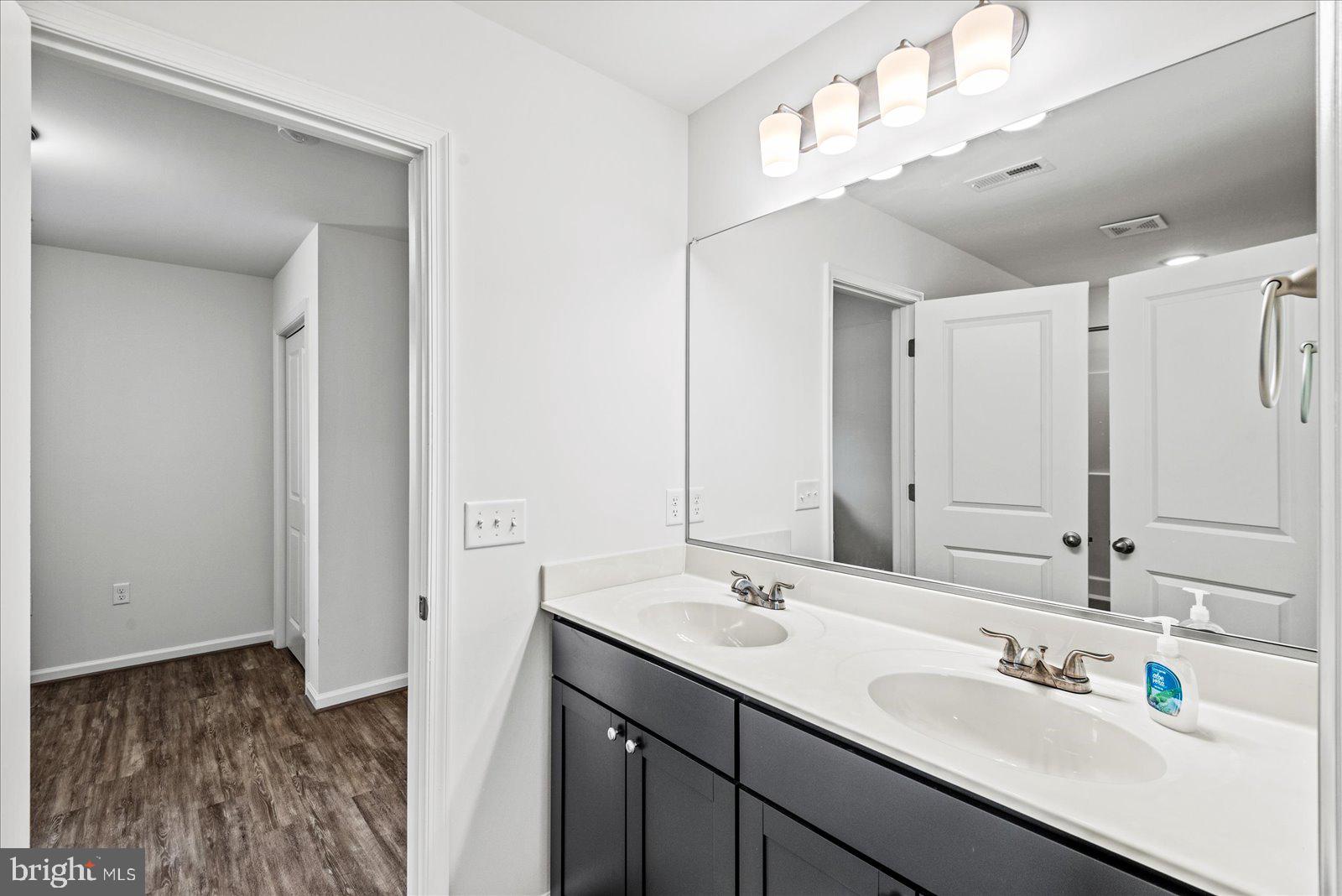 121 1st Street Colonial Beach, VA 22443 - Photo 17 of 46 a bathroom with a sink double vanity and a mirror