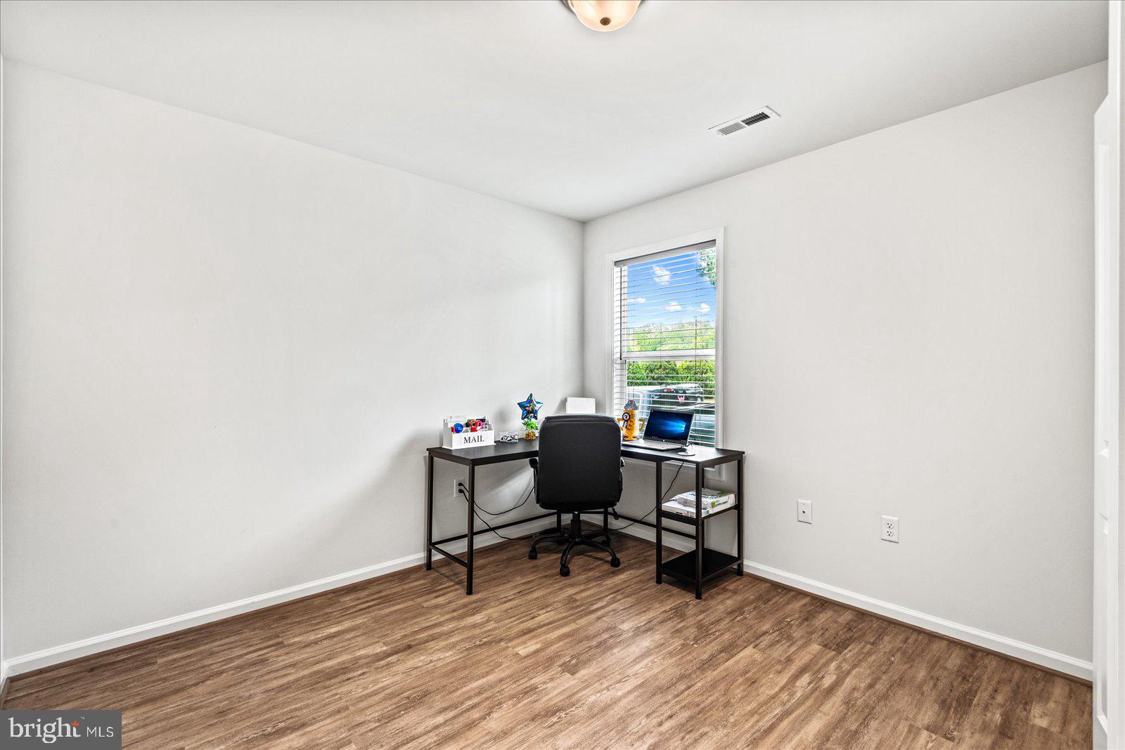 121 1st Street Colonial Beach, VA 22443 - Photo 22 of 46 a view of a workspace with furniture and a window
