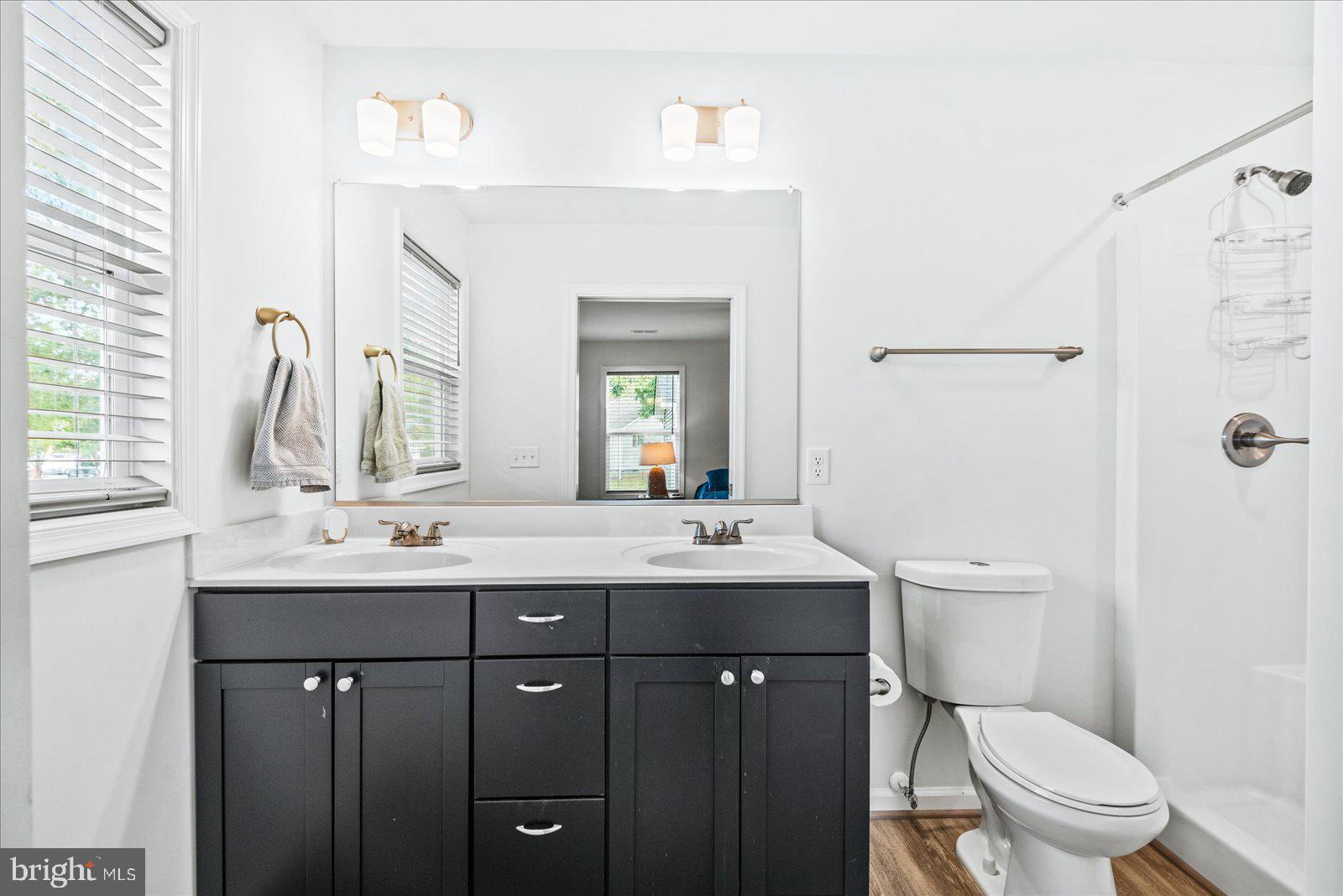 121 1st Street Colonial Beach, VA 22443 - Photo 24 of 46 a bathroom with a double vanity sink toilet and a mirror