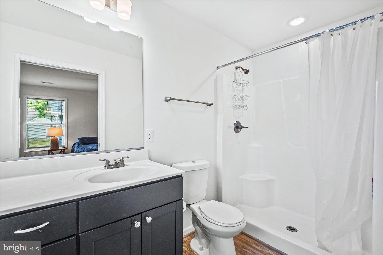 121 1st Street Colonial Beach, VA 22443 - Photo 25 of 46 a bathroom with a sink toilet a mirror and shower