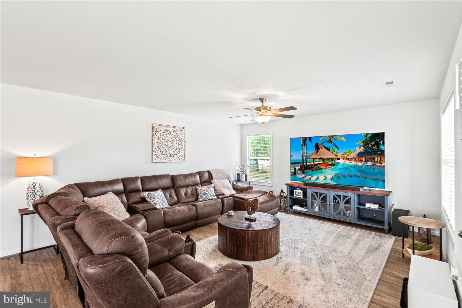 121 1st Street Colonial Beach, VA 22443 - Photo 5 of 46 a living room with furniture a rug and a flat screen tv