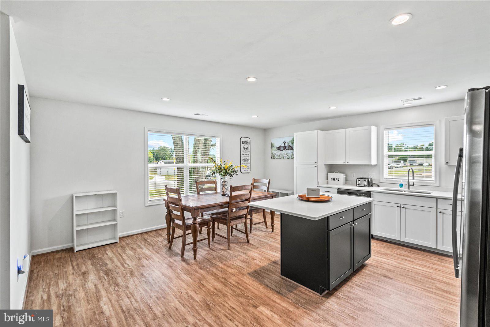 121 1st Street Colonial Beach, VA 22443 - Photo 9 of 46 a kitchen with a stove sink cabinets and wooden floor