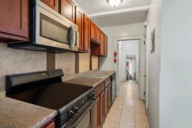 a kitchen with stainless steel appliances a stove microwave and cabinets