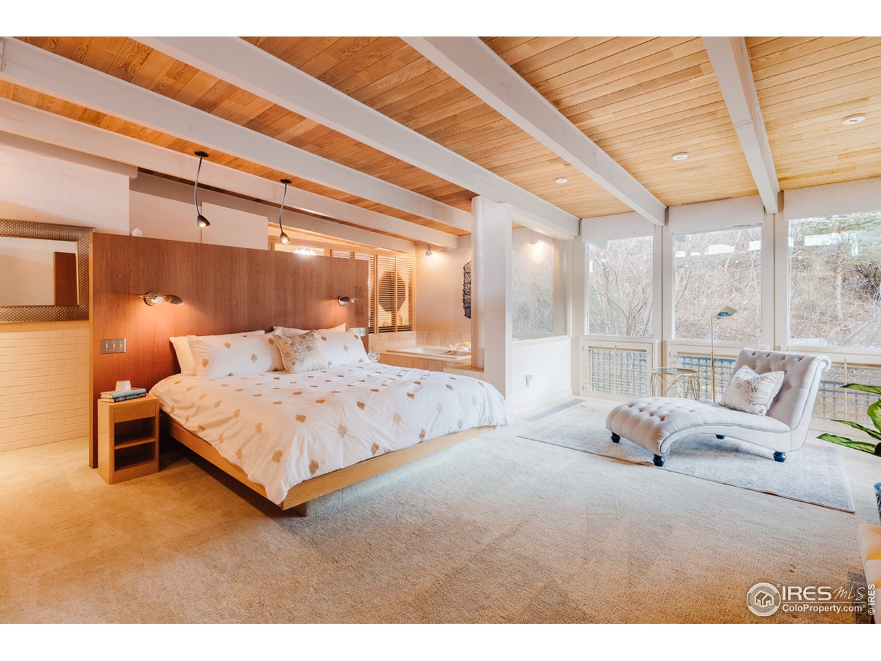 985 7th Street Boulder, CO 80302 - Photo 18 of 39 a bedroom with a bed and large windows