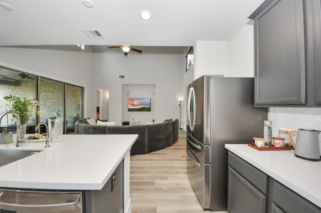 a kitchen with stainless steel appliances a refrigerator and a stove