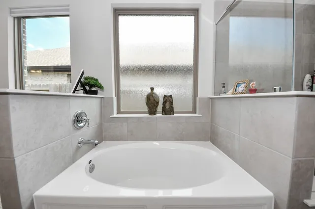a bath tub sitting next to a window