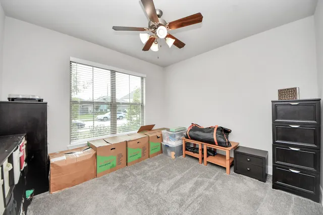 a bedroom with furniture and a flat screen tv