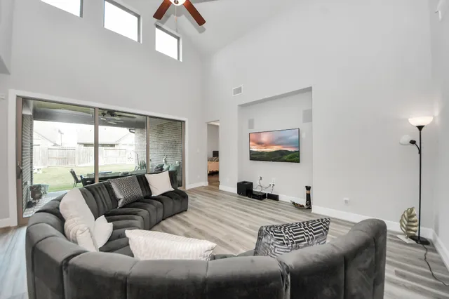 a bedroom with furniture and a large window