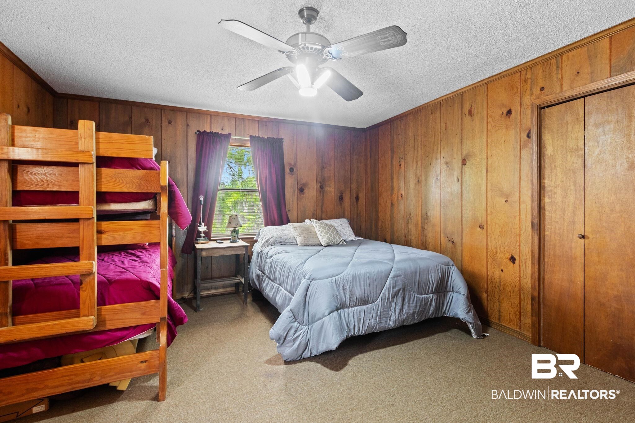 8153 Bryant's Lndg Road Stockton, AL 36579 - Photo 42 of 87 Bedroom featuring wood-panel walls, carpet flooring, and a ceiling fan with integrated lighting
