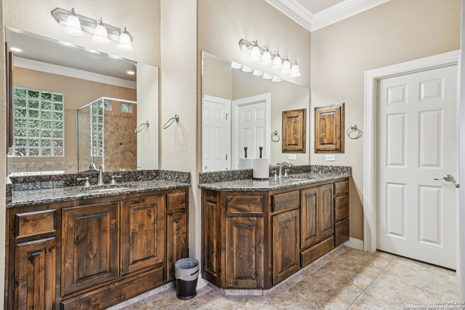 718 Ruidosa Downs Helotes, TX 78023 - Photo 48 of 50 a bathroom with a granite countertop double vanity sink a mirror and a bathtub