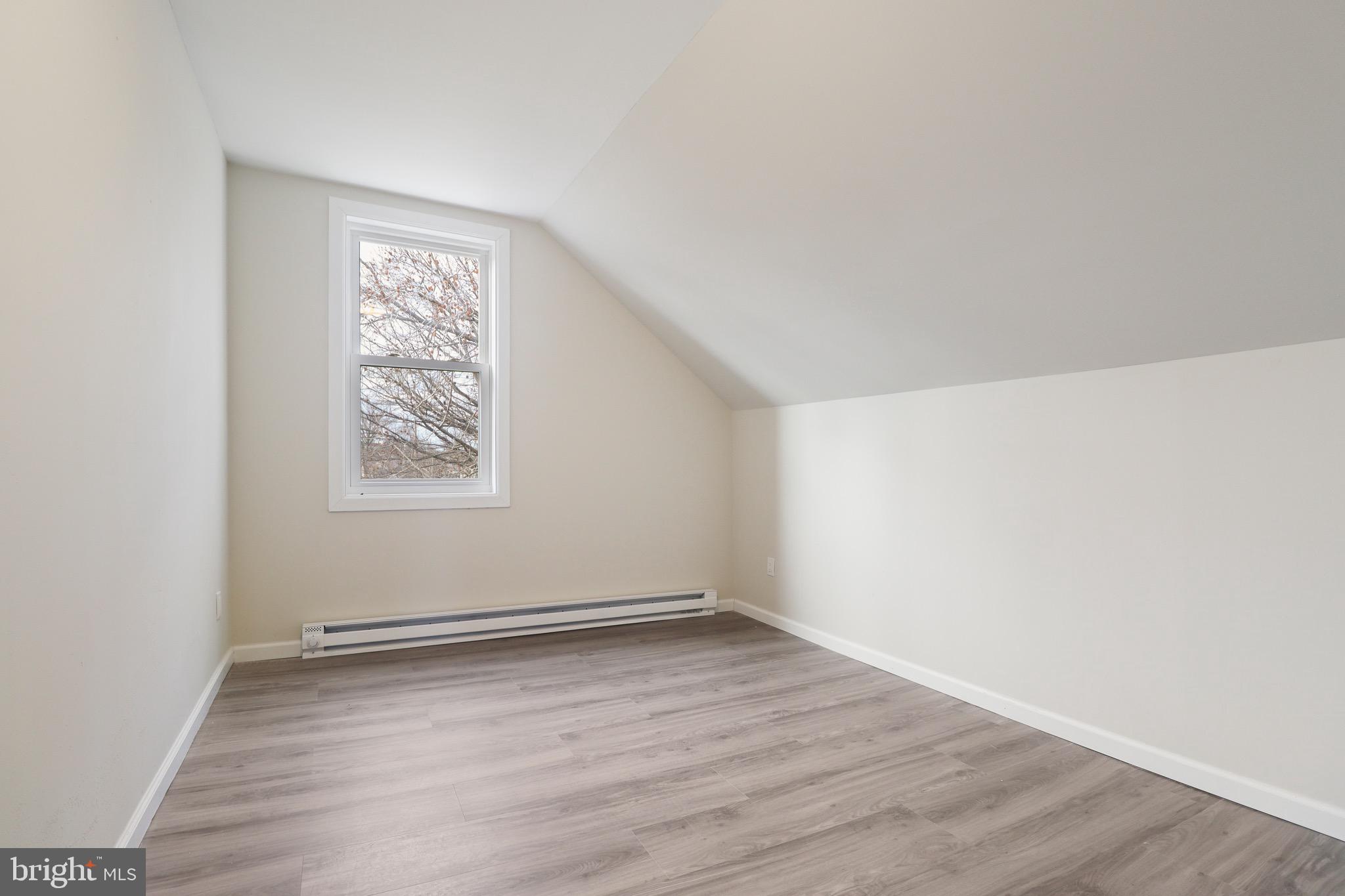 155 7th Street Salem, NJ 08079 - Photo 15 of 20 an empty room with wooden floor and windows
