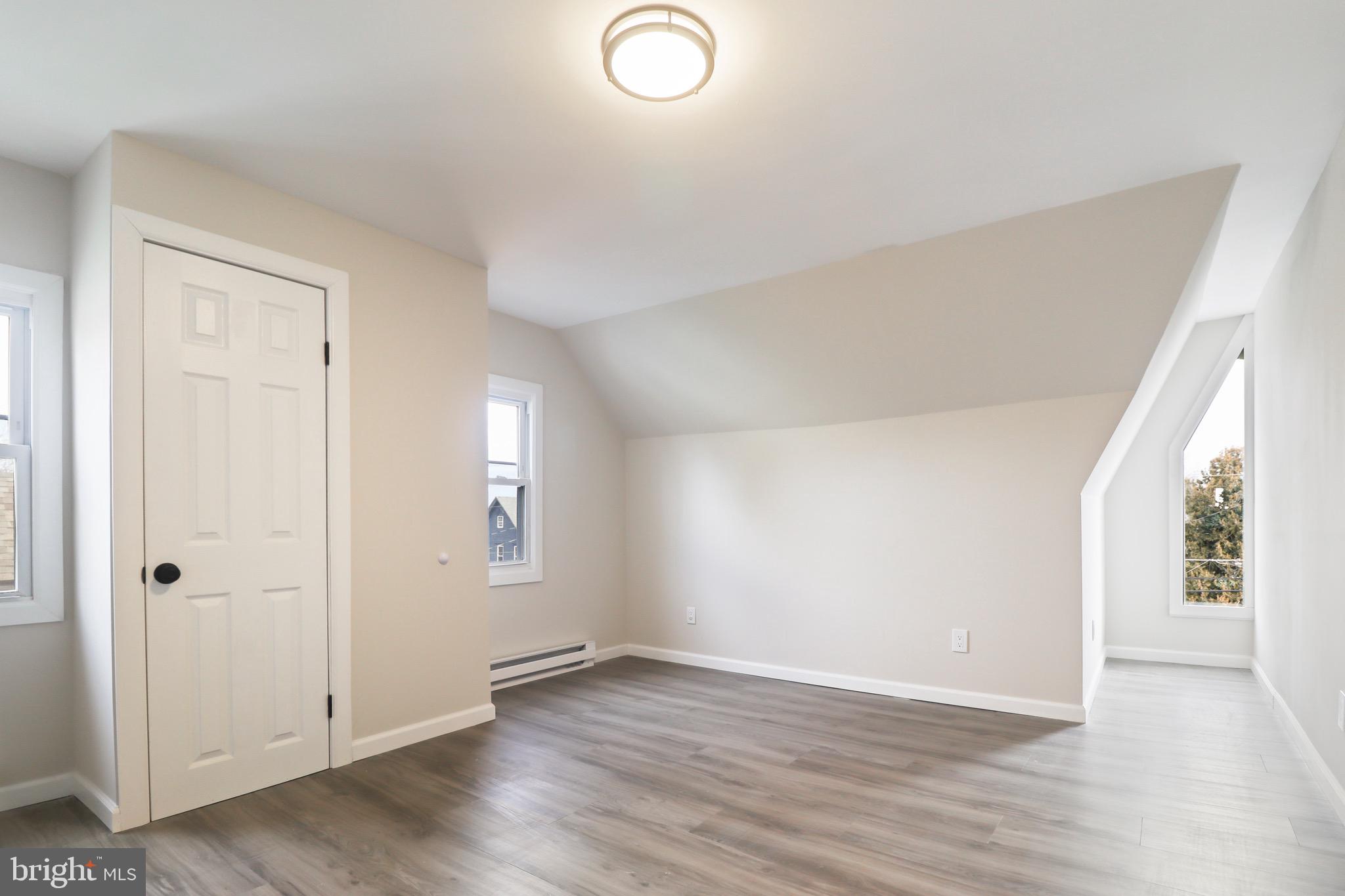 155 7th Street Salem, NJ 08079 - Photo 17 of 20 an empty room with wooden floor and windows