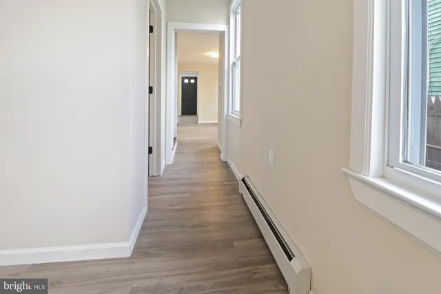 a view of a hallway with wooden floor
